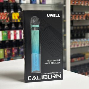 Uwell Caliburn A3S Lake Green POD-система мініатюрний вейп в упаковці на полиці вейп шопа